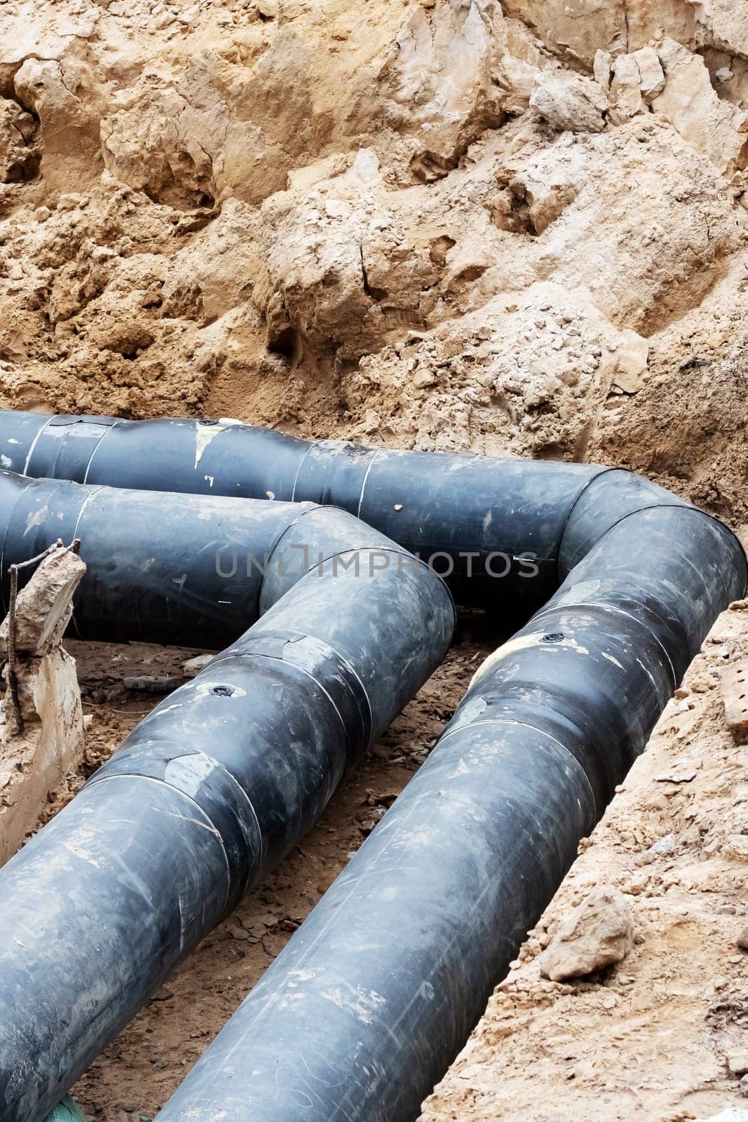 Black water pipe in the ground close up