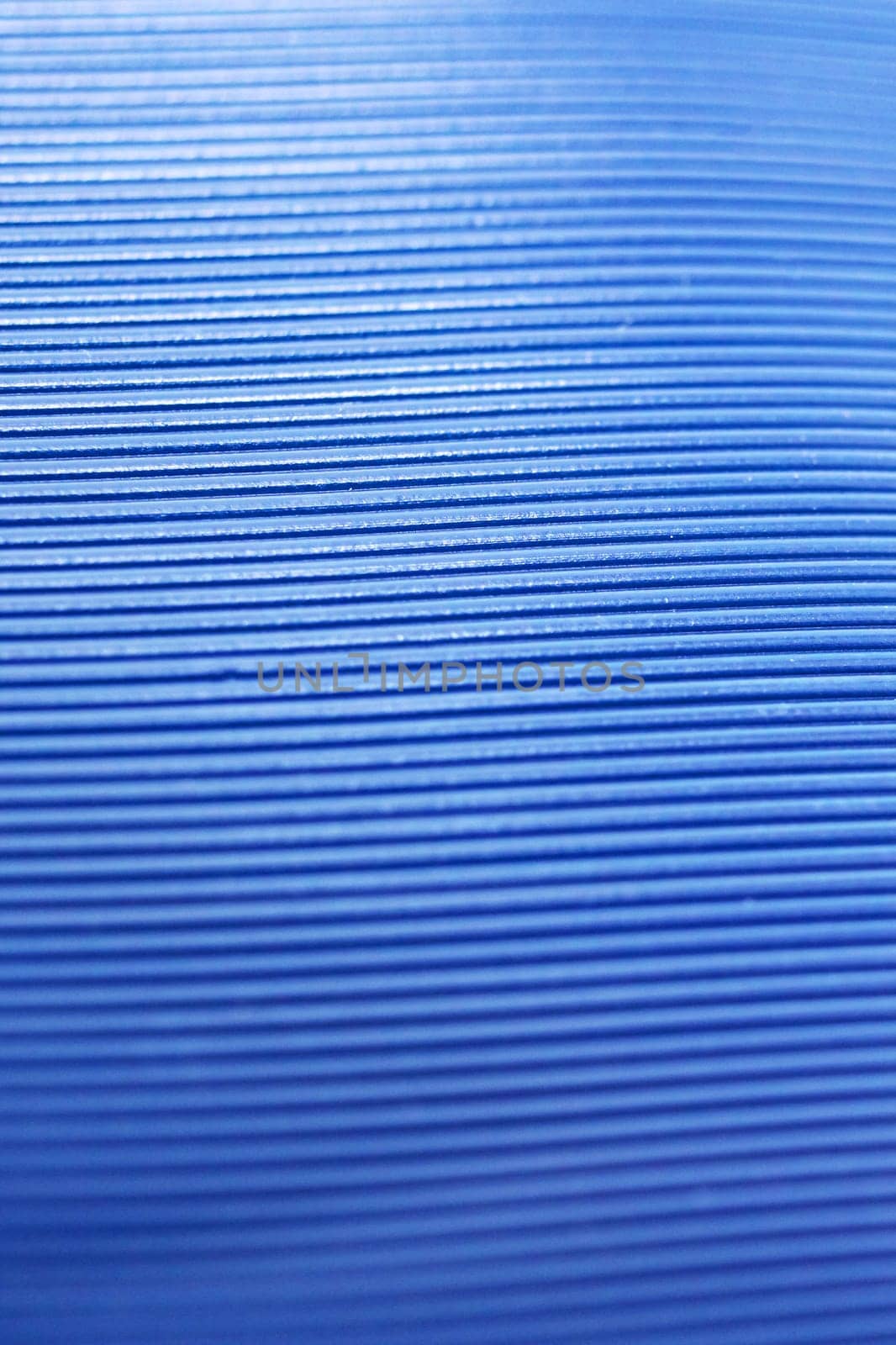 Abstract background of blue stripes on plastic close up