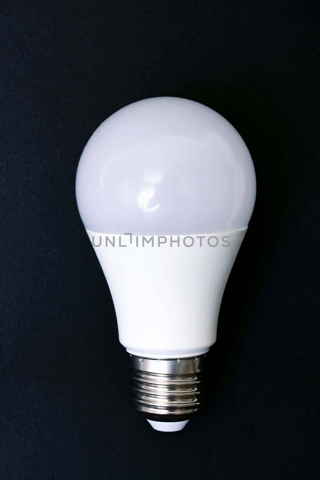 White light bulb and the word idea on a gray background, copy space