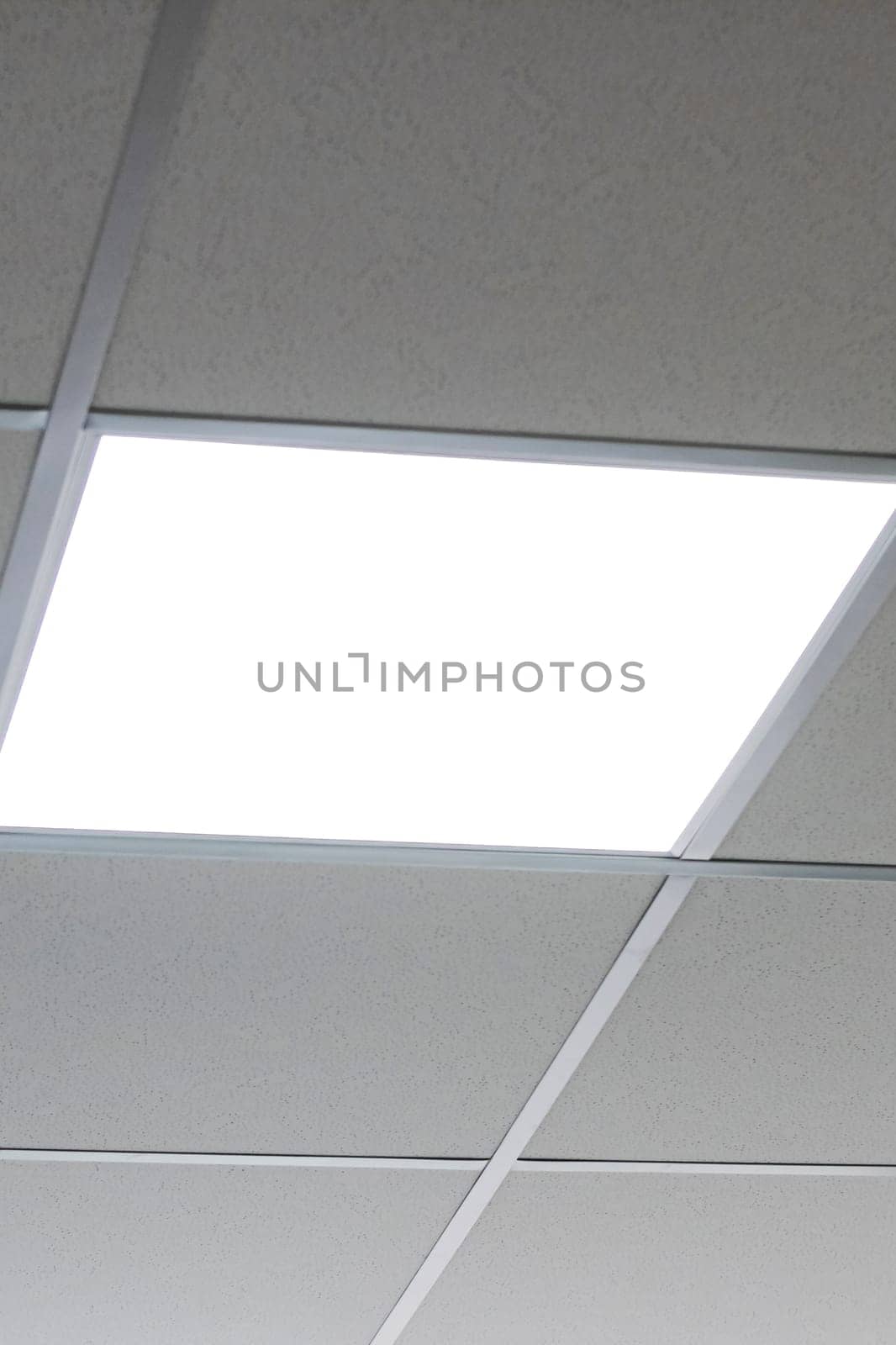 Square lamps on the tiled ceiling close up