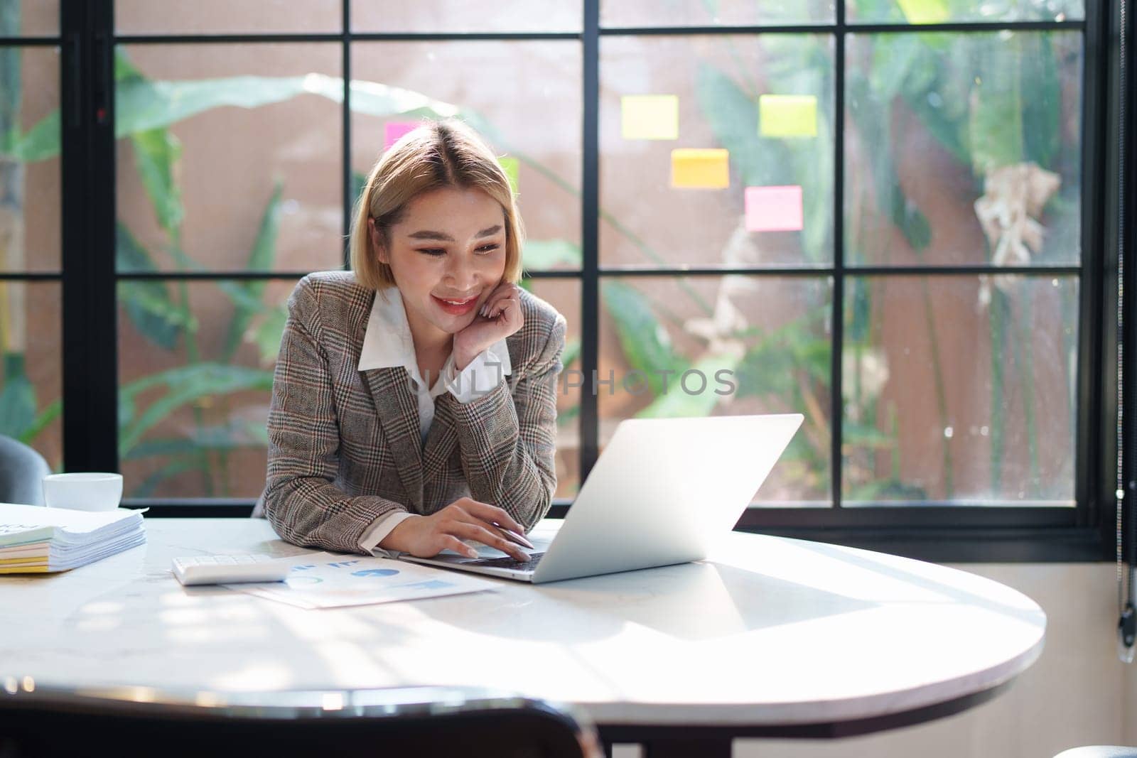 Portrait of Business woman analytic finance statistics and planning strategy by laptop. tax, report, accounting concept.