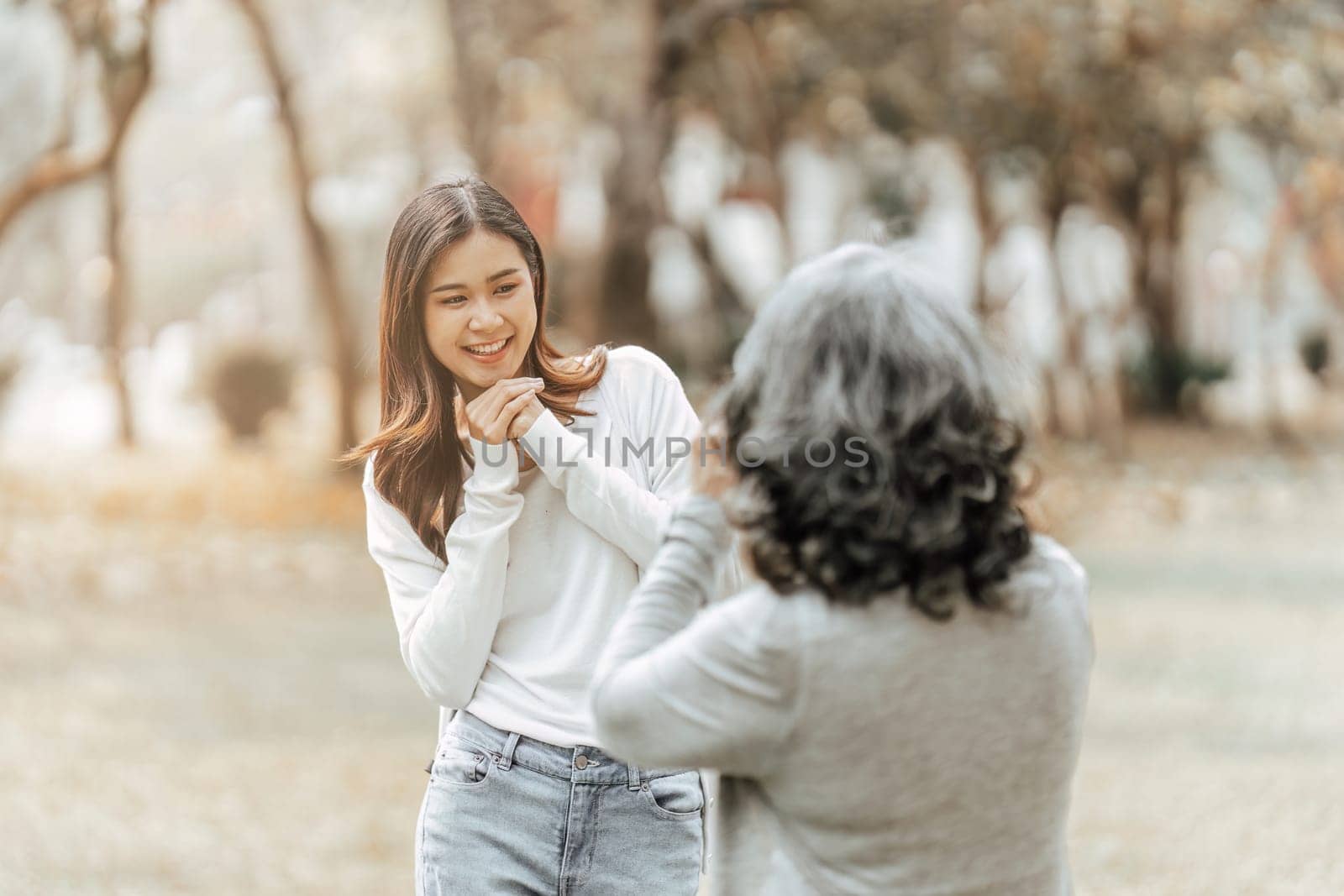 Portrait of an adult daughter with her elderly mother and take a photo and happy moment.