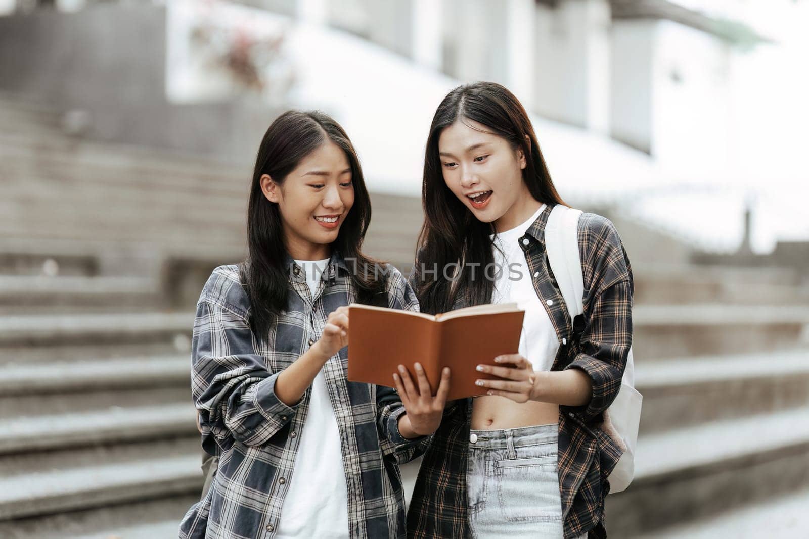 Young Asian woman college student with friends at outdoors. College student working on the college campus, education, school, study.