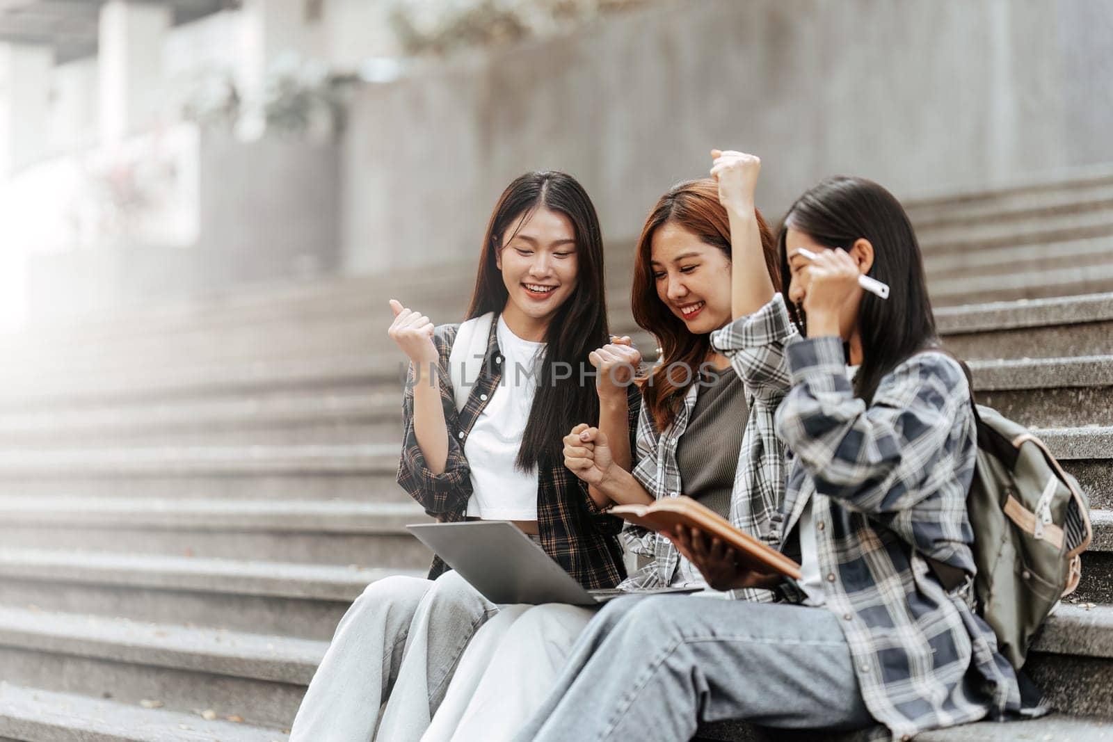 Young Asian woman college student with friends at outdoors. College student working on the college campus, education, school, study by itchaznong