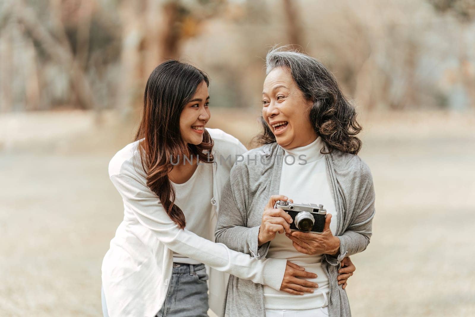 Portrait of an adult daughter with her elderly mother with hug and happy moment.