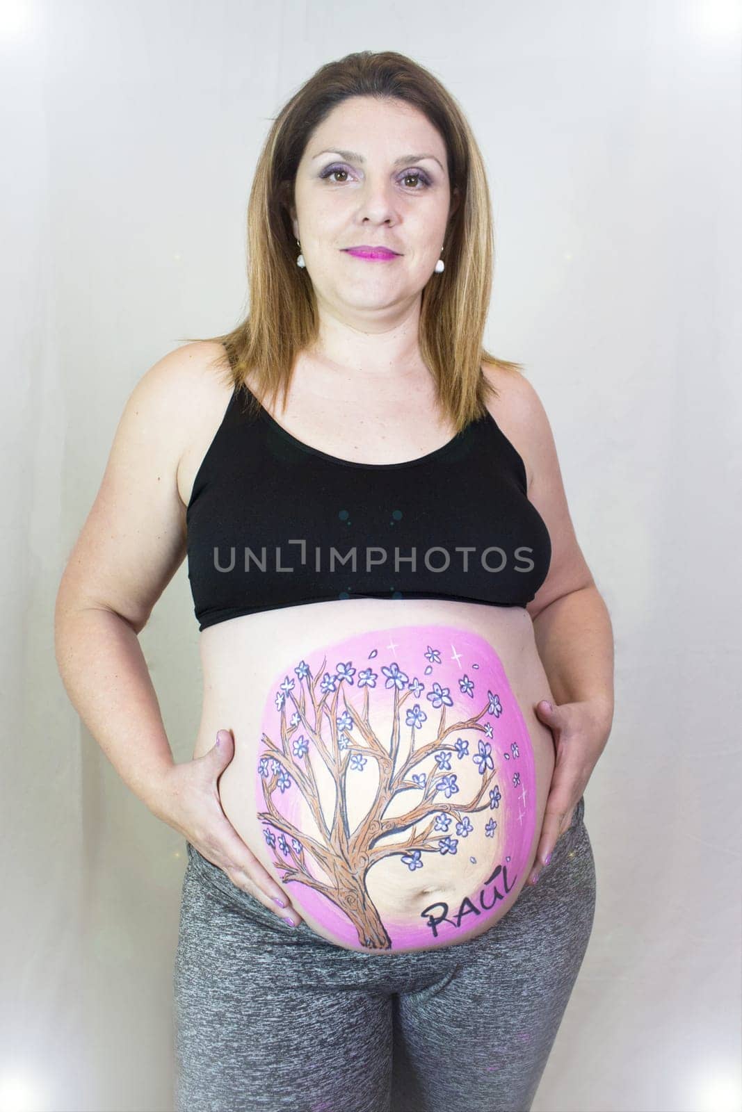 Pregnant woman with drawing on her belly. No copy space