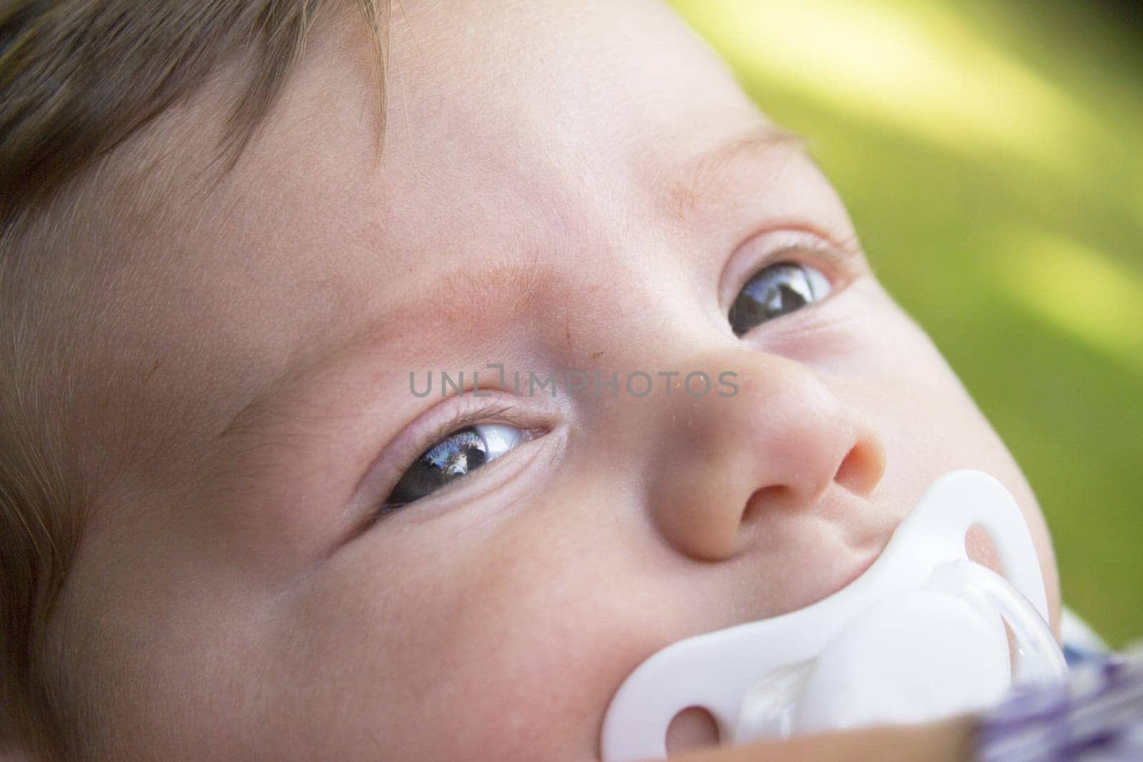 Two month old baby with pacifier. No sleeping