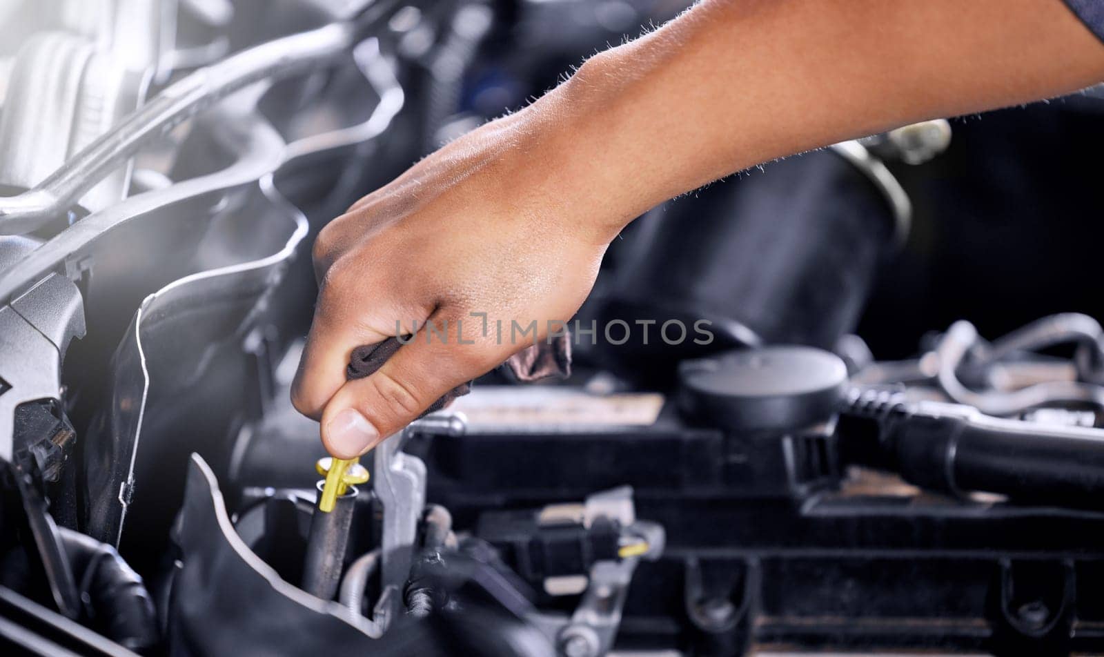 Engineering, repair and mechanic working on a car, doing a service and check for problem with the engine at a workshop. Hands of a transportation technician doing maintenance on a van or vehicle.