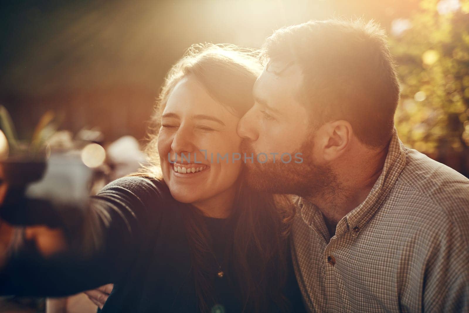Camera selfie, couple kiss and happiness outdoor in summer smile about bonding and care. Travel of a happy boyfriend and girlfriend in nature on a walking or hiking travel feeling freedom and love.