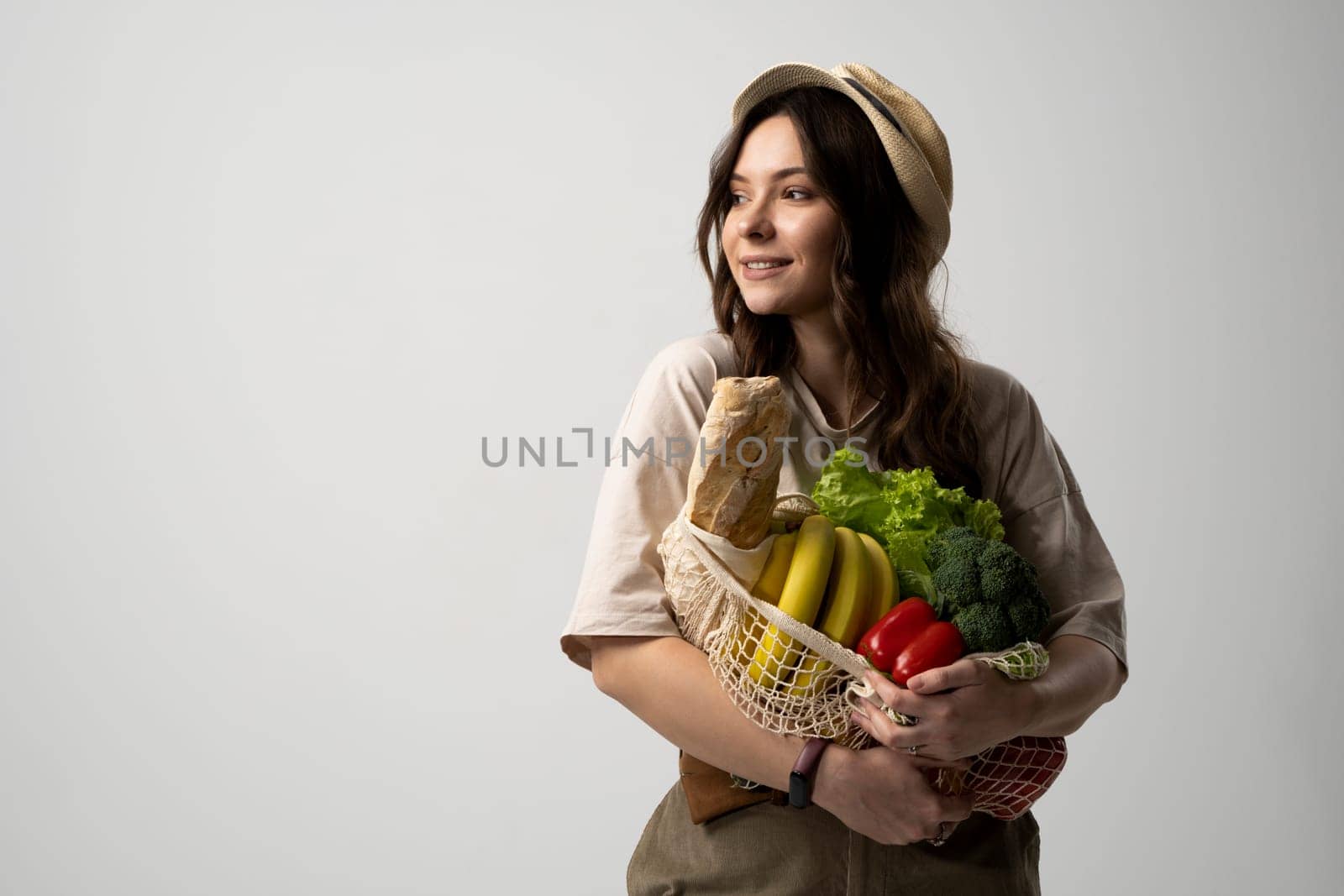Portrait of young woman with a eco bag of vegetables, greens. Sustainable lifestyle. Eco friendly concept