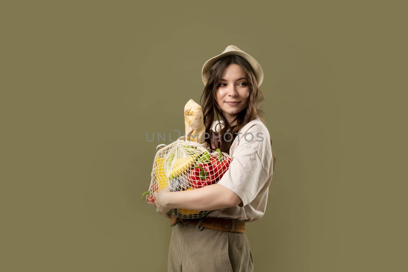 Zero waste concept. Woman holding reusable cotton shopping mesh bag with groceries from a market. Concept of no plastic. Zero waste, plastic free. Eco friendly concept. Sustainable lifestyle