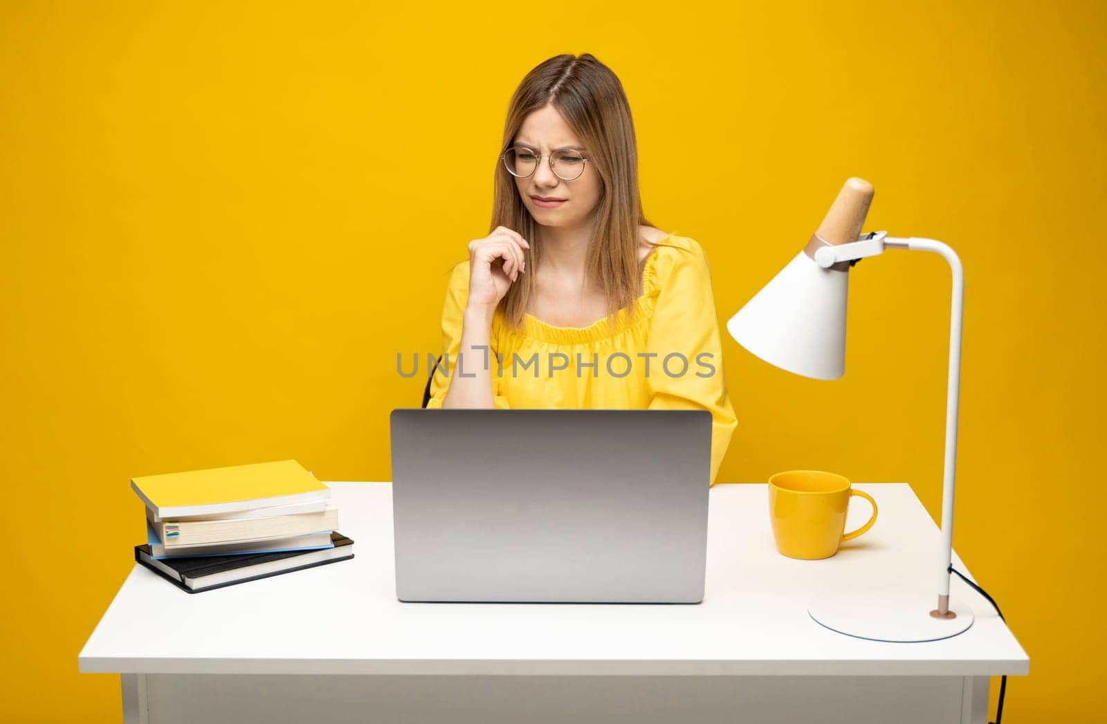 Frustrated, sad, stressed or depressed woman feeling tired while working with a laptop on a black background.