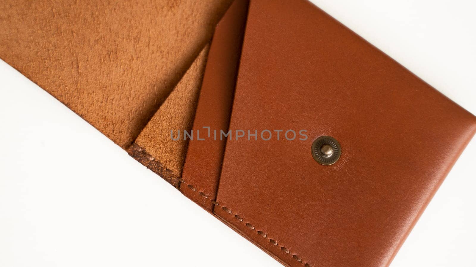 Orange empty men's business handmade leather card holder with isolated on white background. Selective focus, copy space, close up