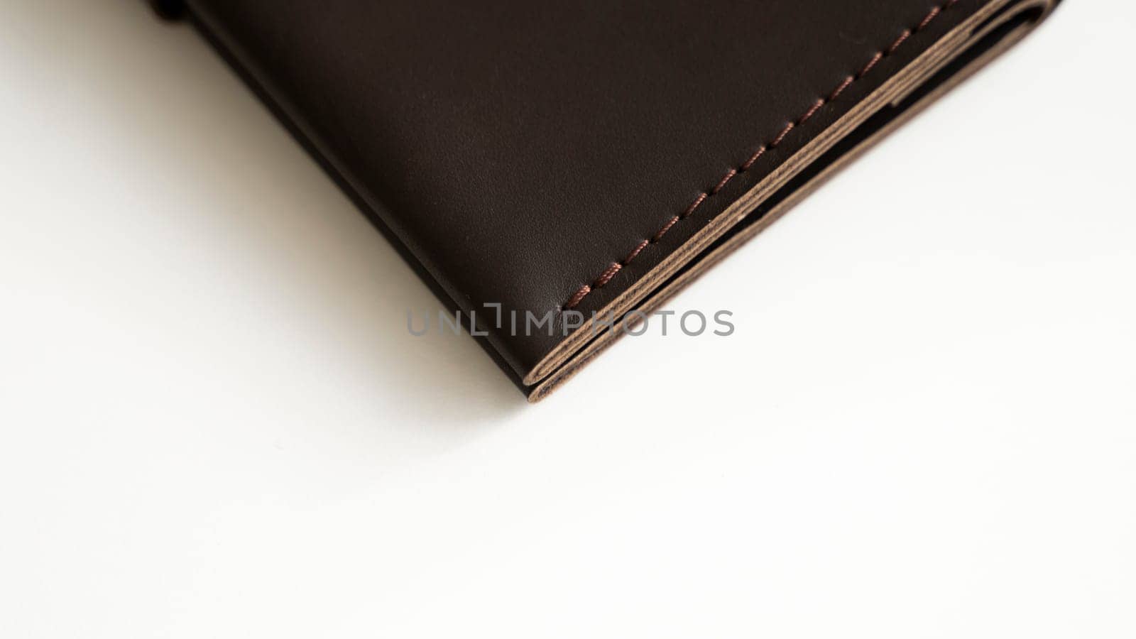 Details of brown elegance men's leather wallet on a white background. Mens leather accessories. Natural leather