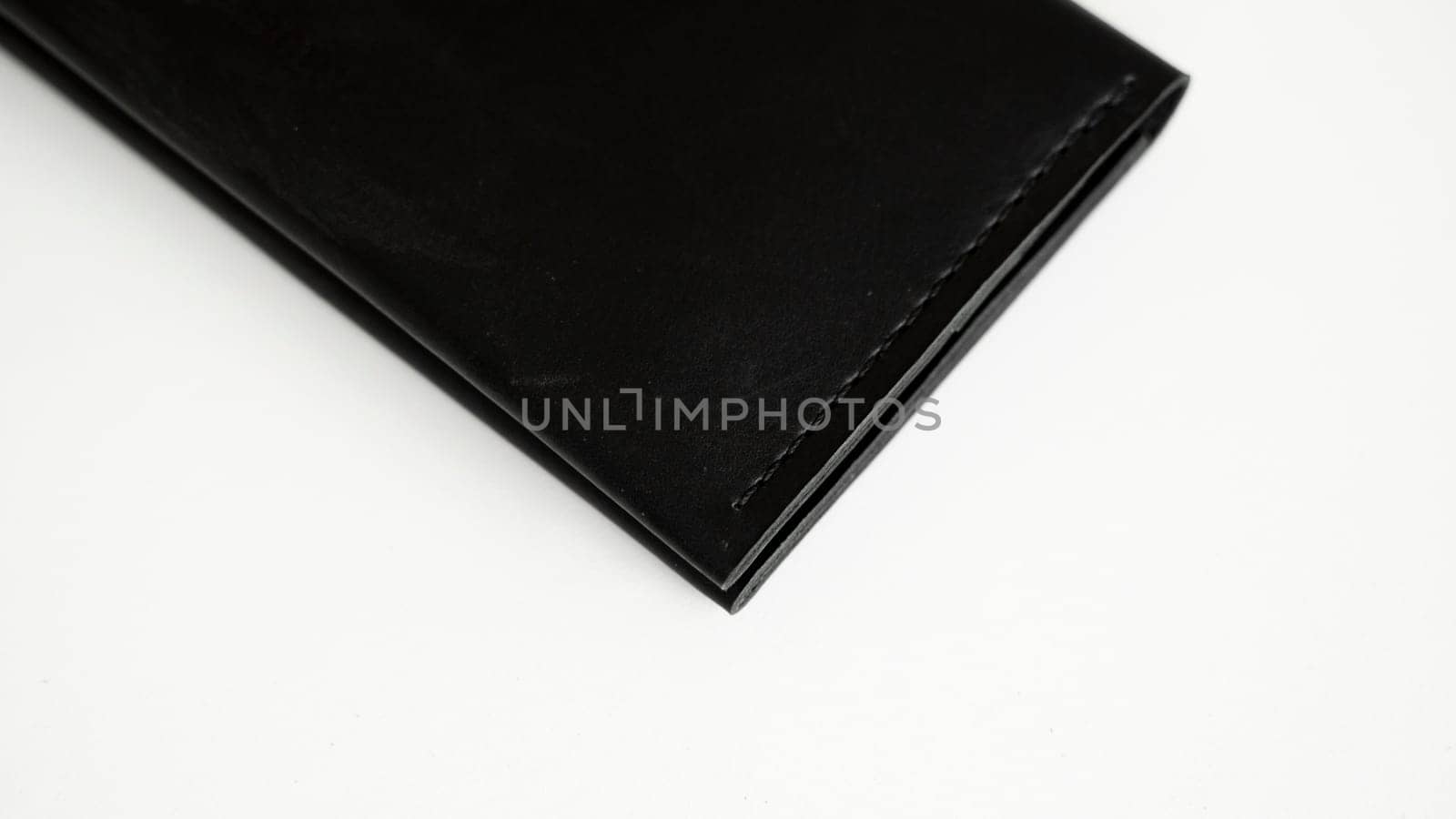 Details of black genuine leather wallet on a white background. Men's accessories