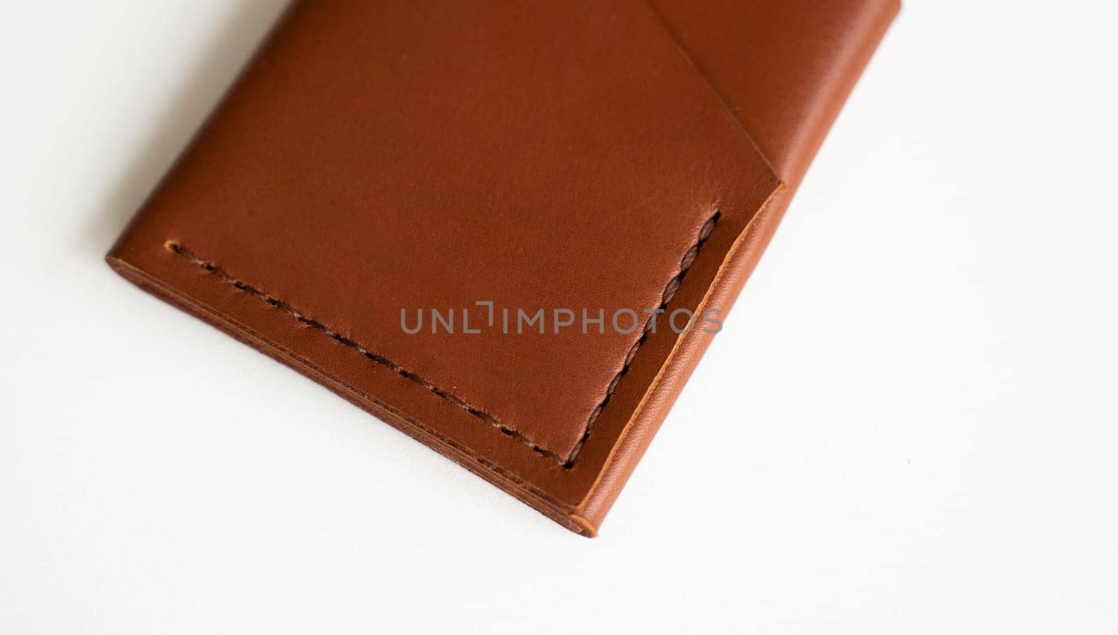 Empty men's business handmade leather card holder with isolated on white background. Selective focus, copy space, close up