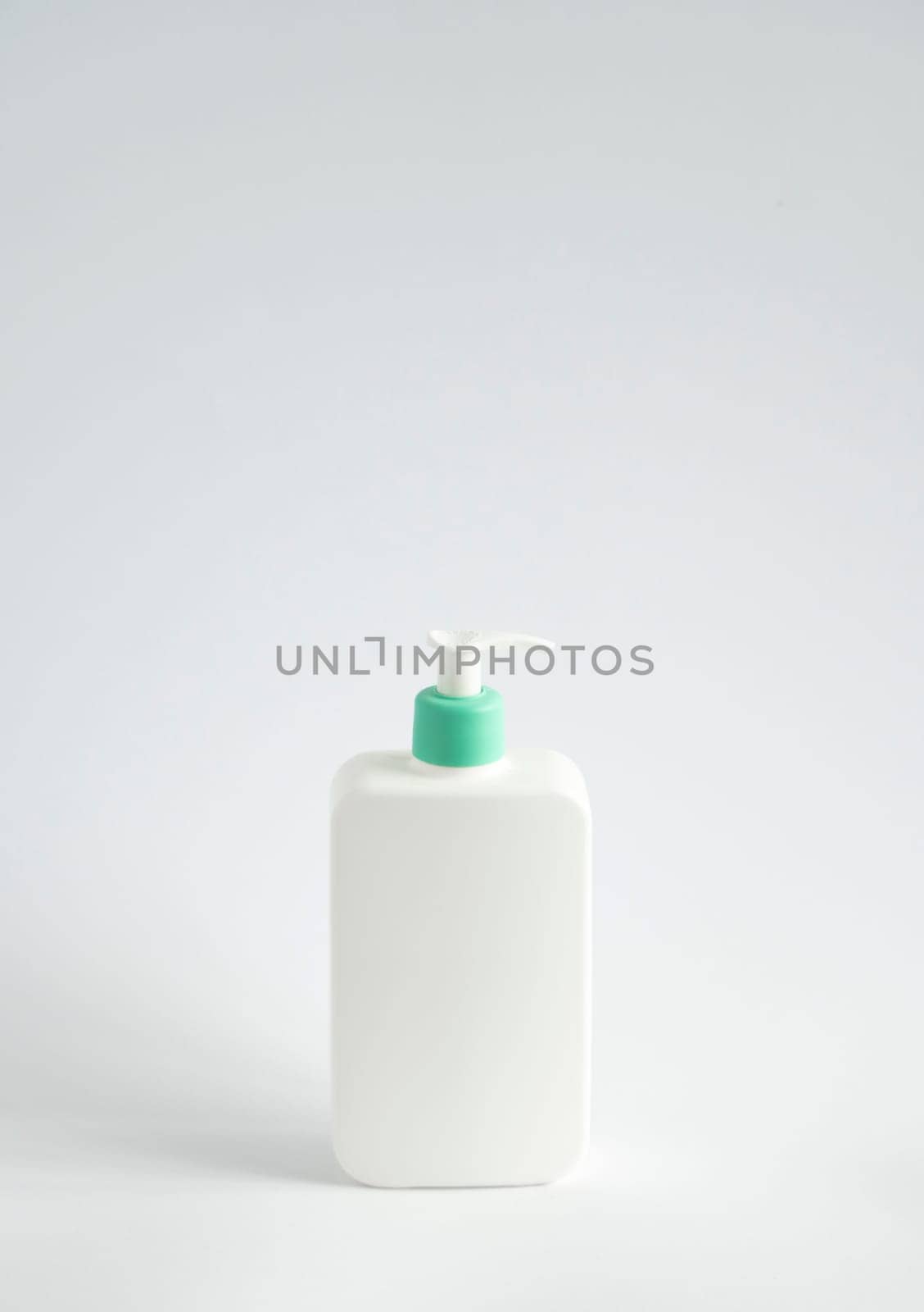 Blank body cream, lotion, shampoo or shower gel bottle photo. White plastic container isolated on white background. by vovsht