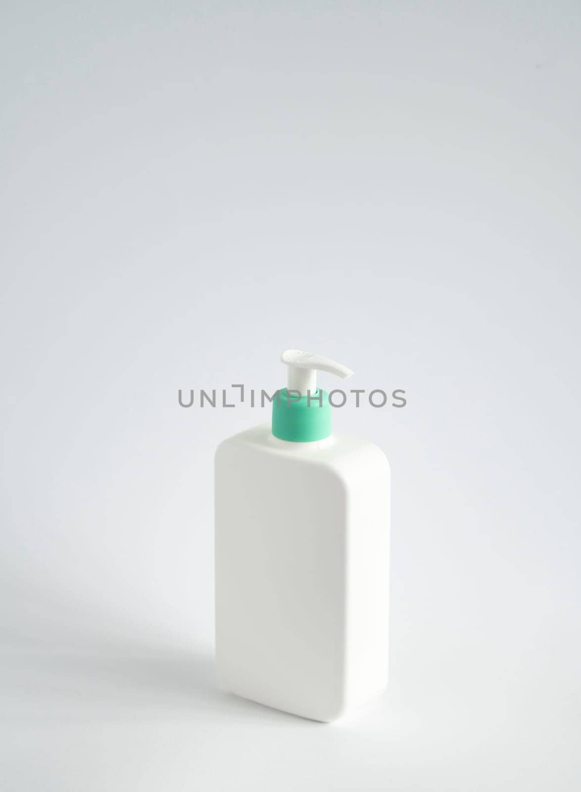 Large white plastic bottle with pump dispenser as a liquid container for gel, lotion, cream, shampoo, bath foam on white background. by vovsht