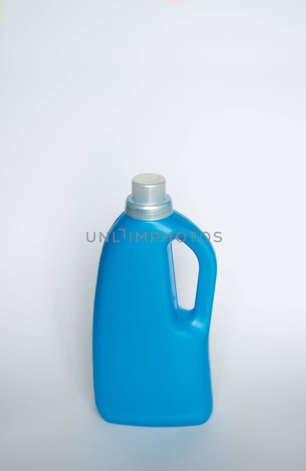 Softener in blue plastic bottle isolated on white background. Bottle with liquid laundry detergent, cleaning agent, bleach or fabric softener. Product design. Mock up. by vovsht