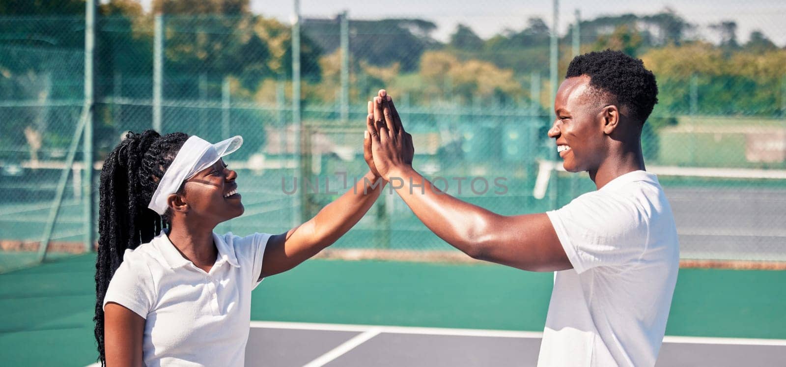 High five, tennis and sports couple or black people with success, competition congratulations or support in game collaboration. Tennis court, athlete and fitness friends with mission or yes hand sign by YuriArcurs