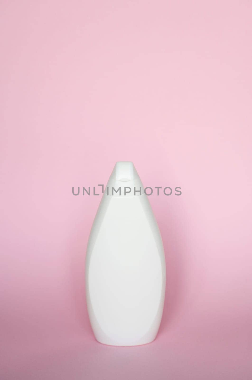 White bottle for liquid soap, shampoo, gel on pink background. by vovsht