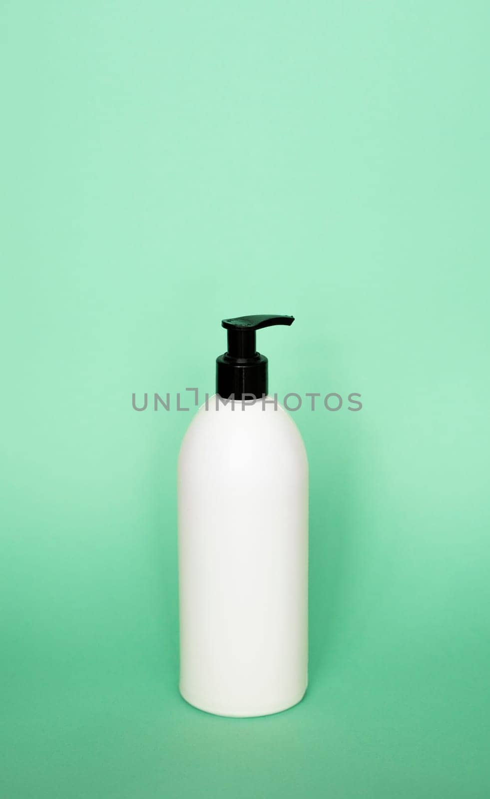 White blank unbranded cosmetic plastic bottle with black dispenser pump for shampoo, gel, lotion, cream, bath foam