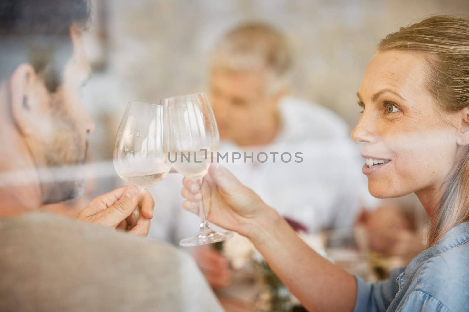 Couple, smile and champagne toast at dinner celebrating in home. Cheers, love and man, woman and sparkling golden wine or alcohol, beverage or drink celebration at party, event or family gathering. by YuriArcurs