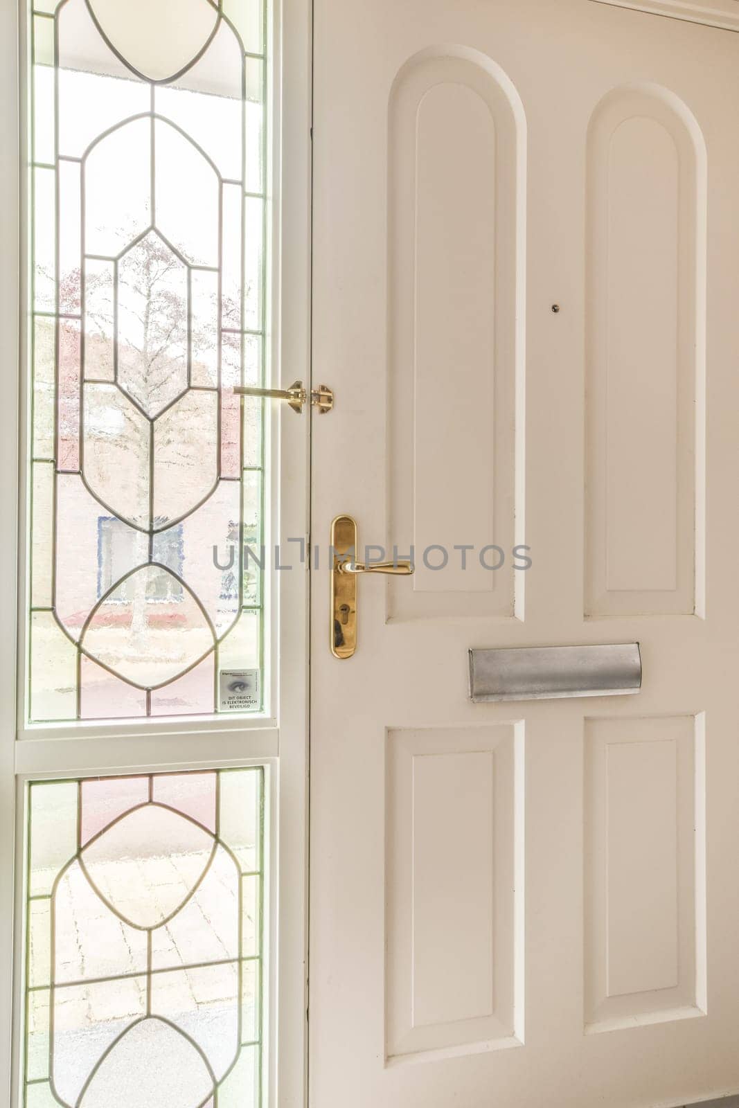 a white door with stained glass in the front and side panels on the outside, as seen from the inside