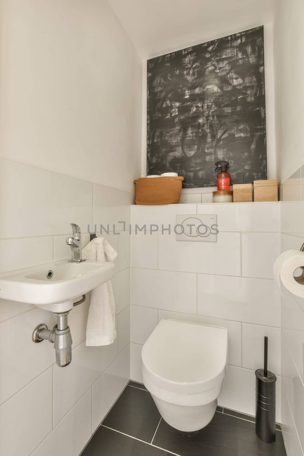 a small white bathroom with a toilet and a sink by casamedia