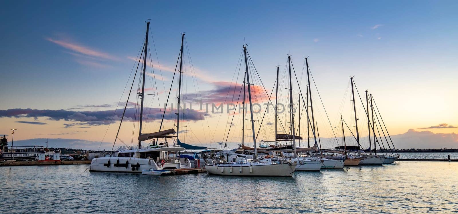 Panoramic view of Yachts and boats after sunset in the harbor.