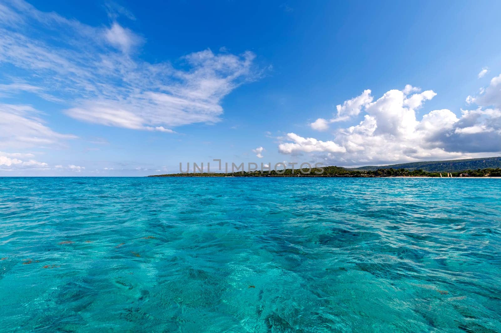 Beautiful landscape from Atlantic ocean to the coastline, turquoise water, and blue sky with clouds. Cuba