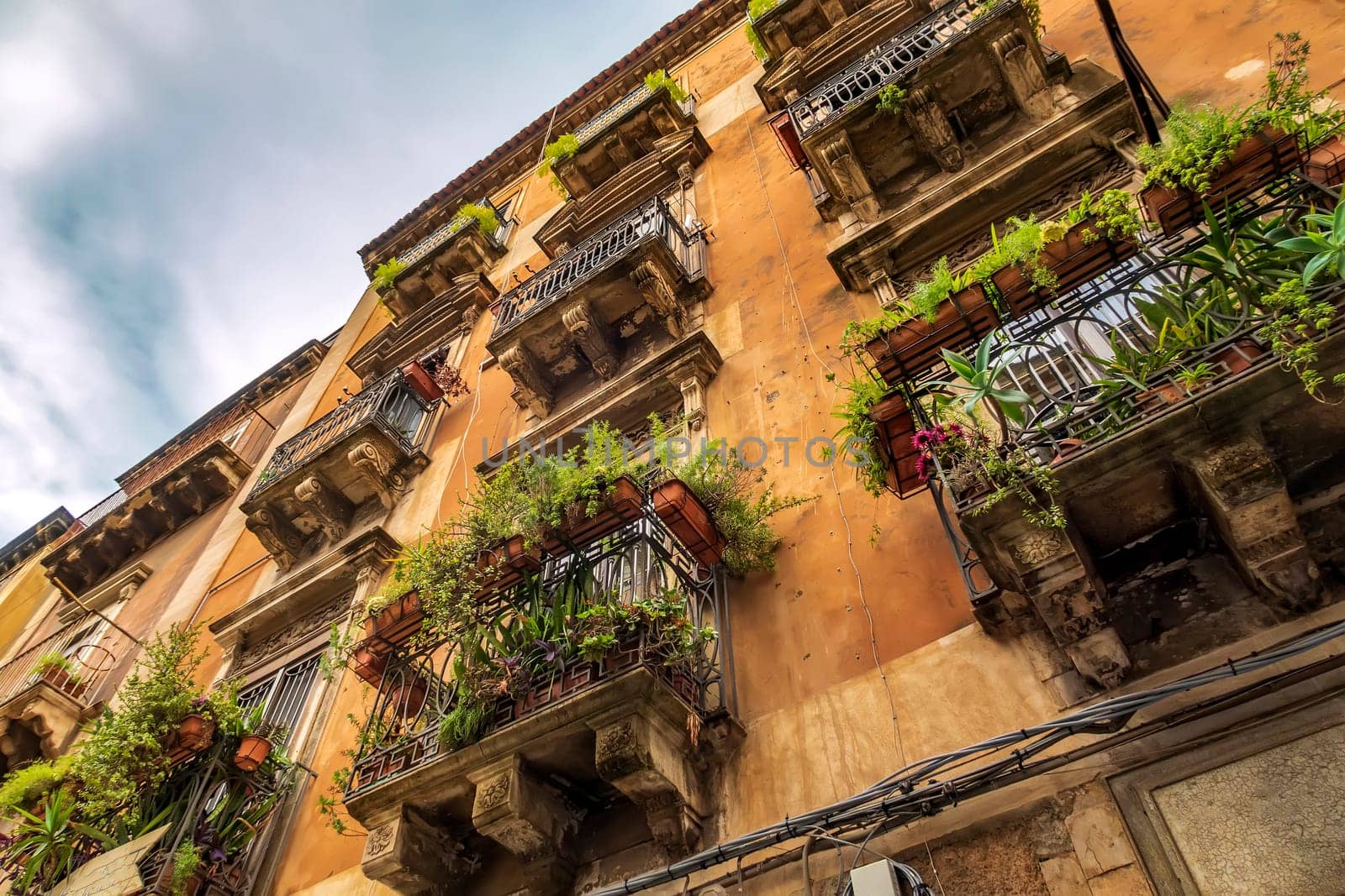 Vintage house with many Balconies with flowers in the City of Catania, Italy.