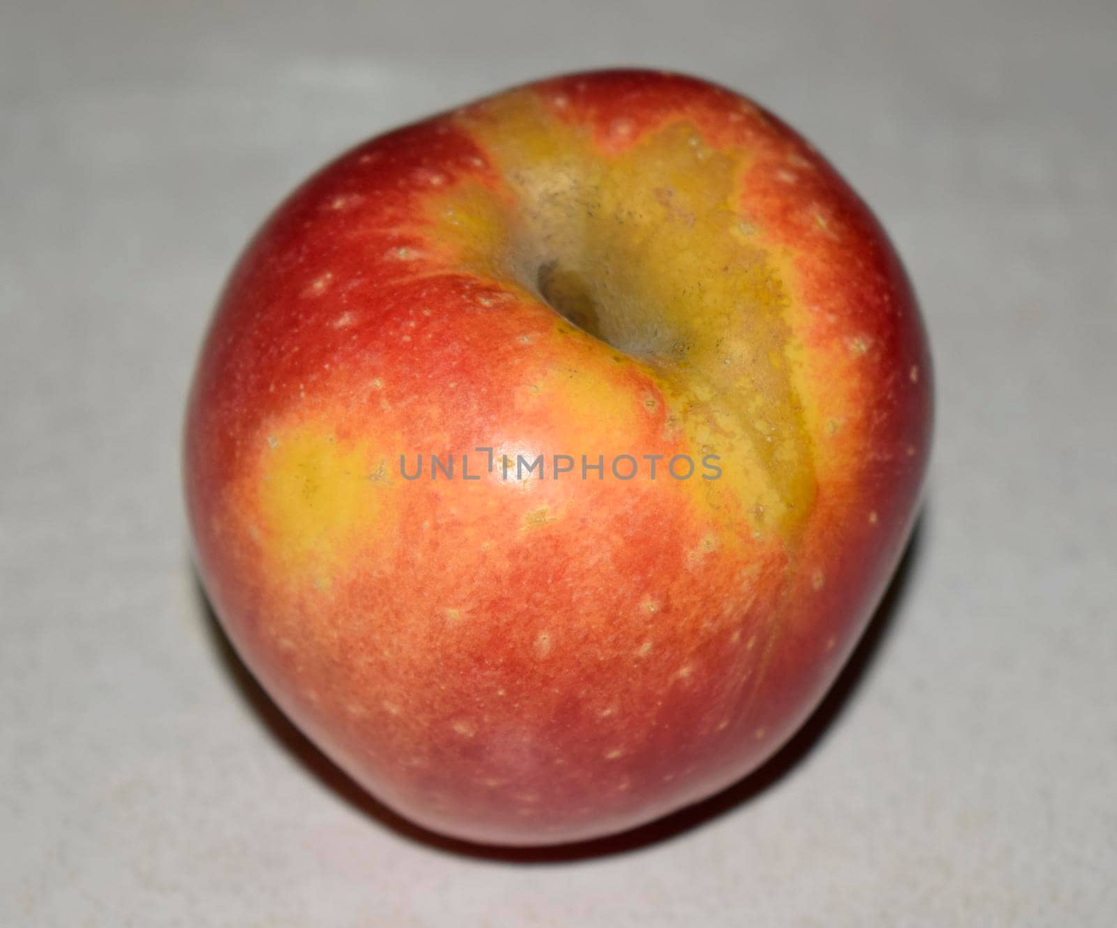 Healthy Eating - High Definition Studio Photo of a Fresh Organic Juicy Red Apple on Neutral Gray Wooden Background