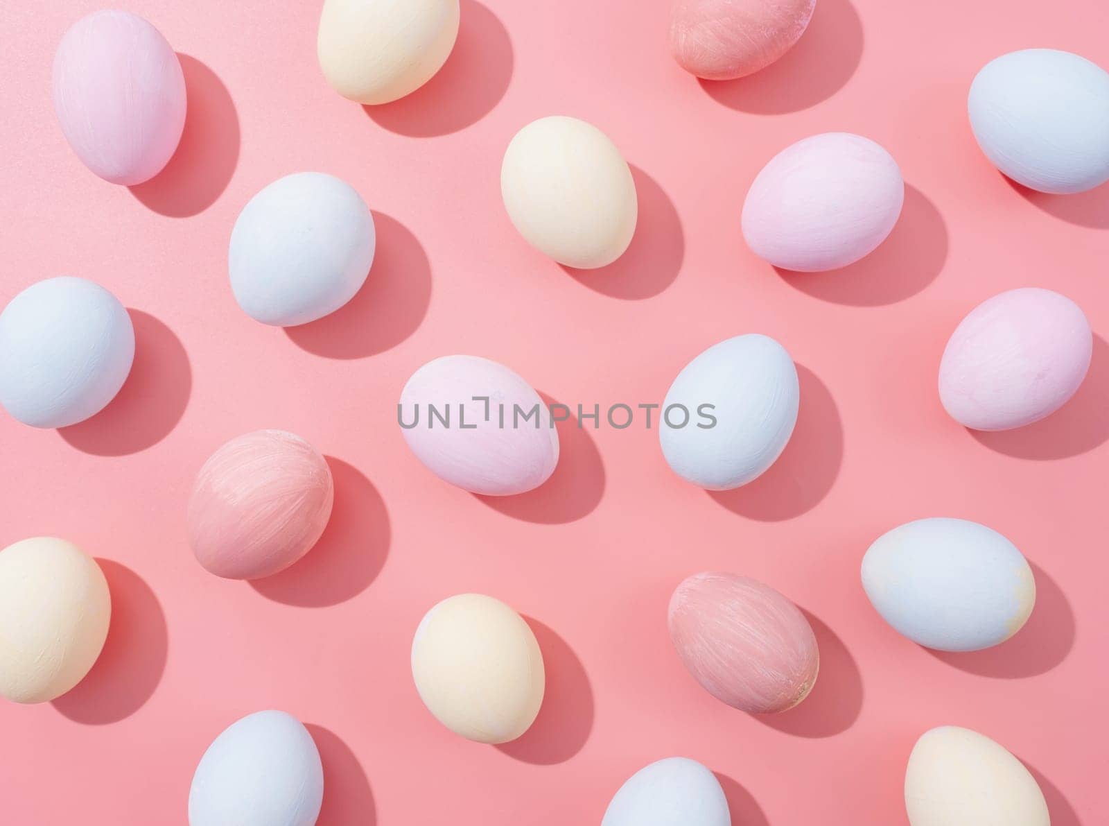 Spring holidays, Happpy Easter. pastel colored easter eggs with hard shadows pattern on pink background