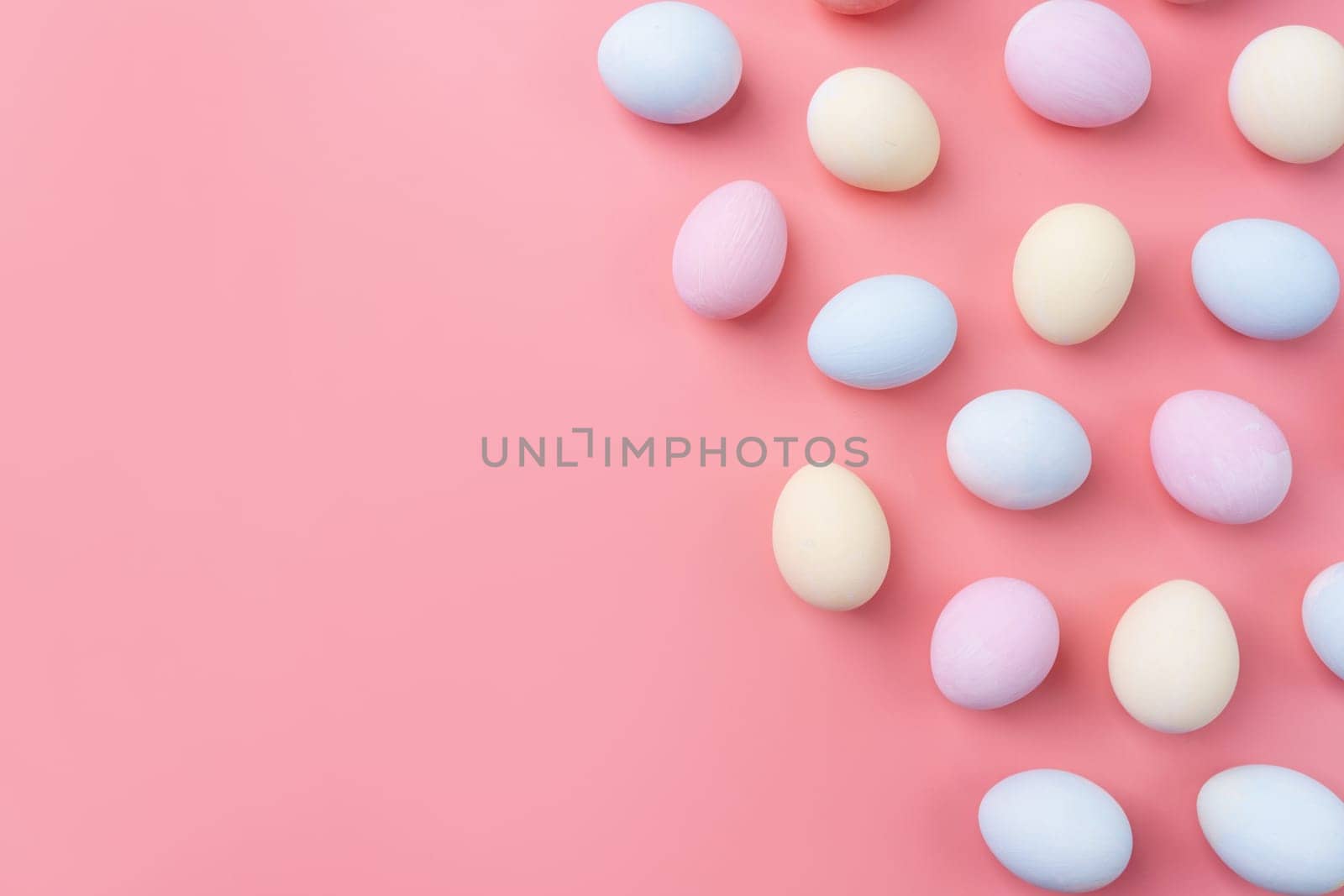 Spring holidays, Happpy Easter. pastel colored easter eggs pattern on pink background