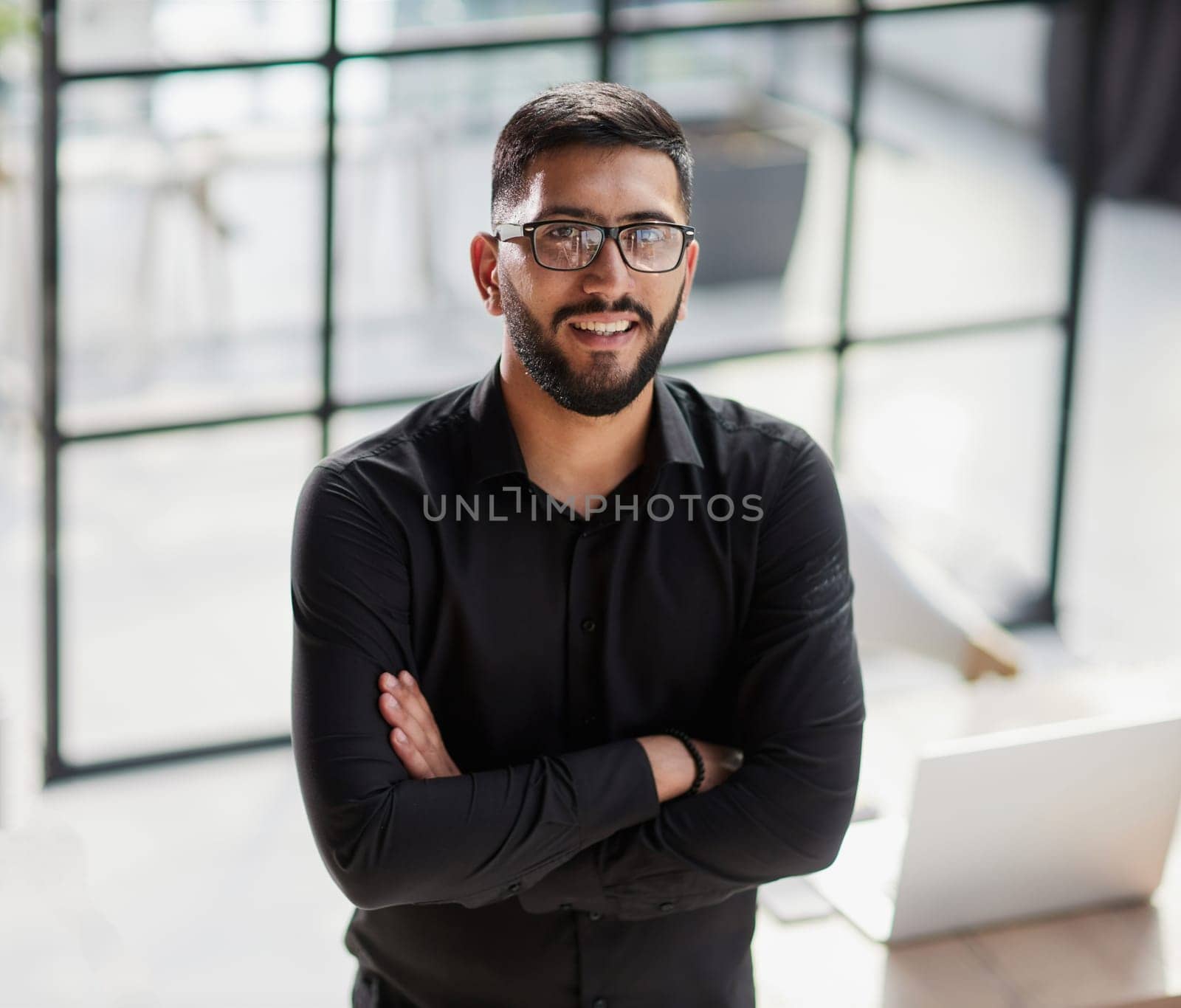Businessman portrait. Happy confident young businessman standing , smiling, looking at camera.