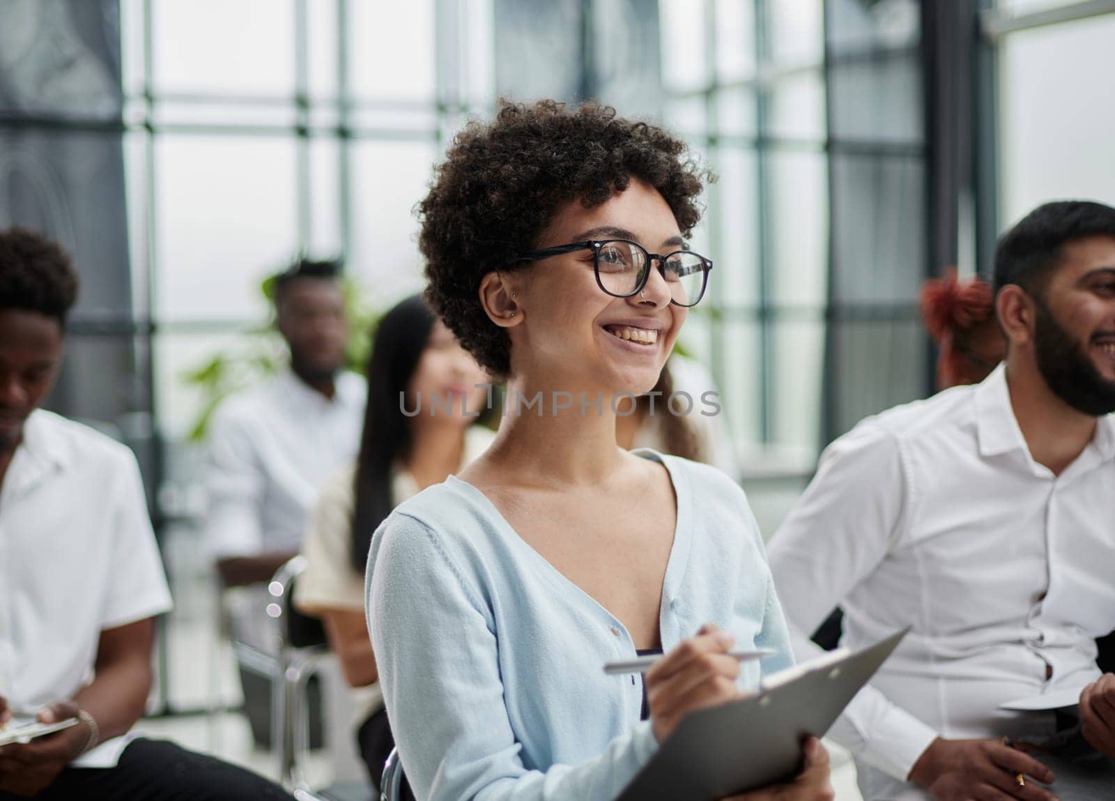 Group of different employees studying at board meeting in modern office or conference room by Prosto