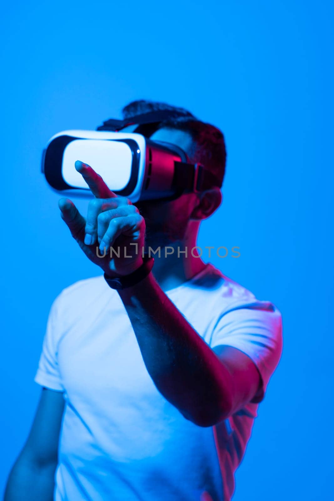 Man wearing virtual vr goggles. Young bearded man wearing virtual reality headset. VR concept. by vovsht