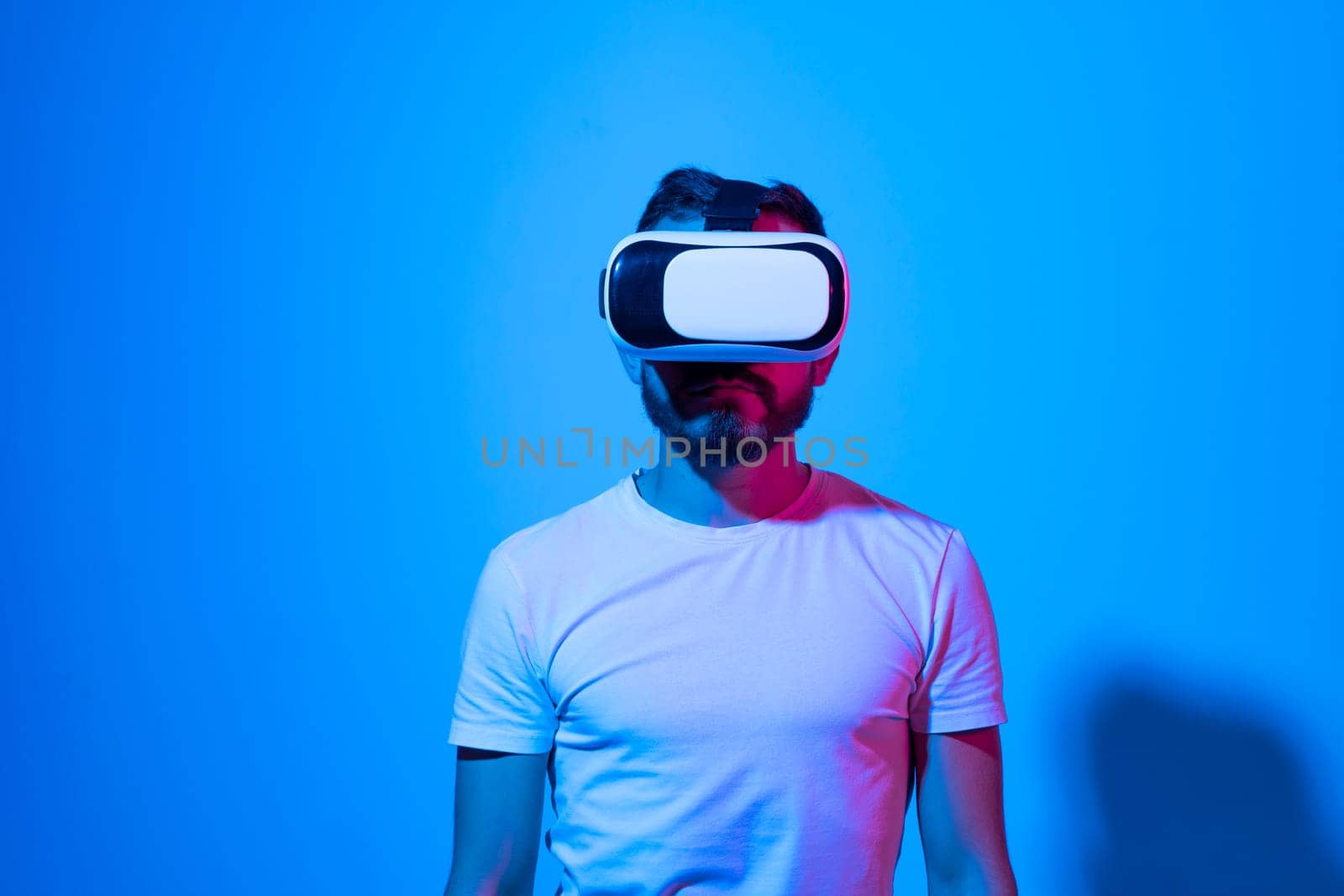 Bearded man in VR glasses. Future, technology and people concept