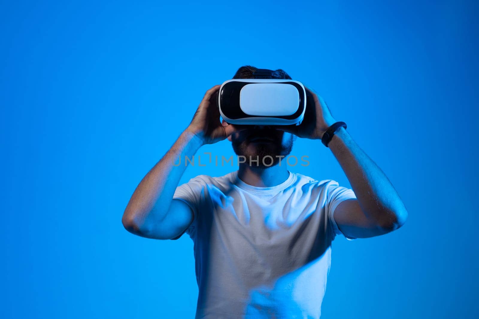 Attractive bearded man wearing virtual reality goggles. VR headset. Virtual reality concept