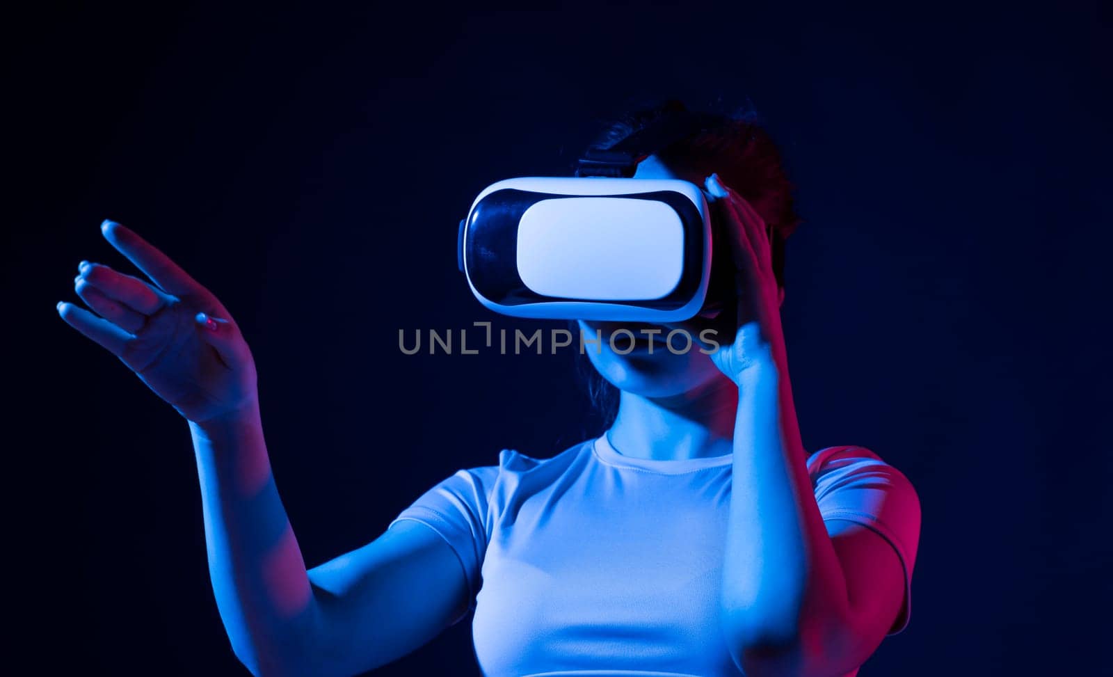 Brunette girl wearing virtual reality goggles at home. Gaming, remote education, online education, indoor lifestyle