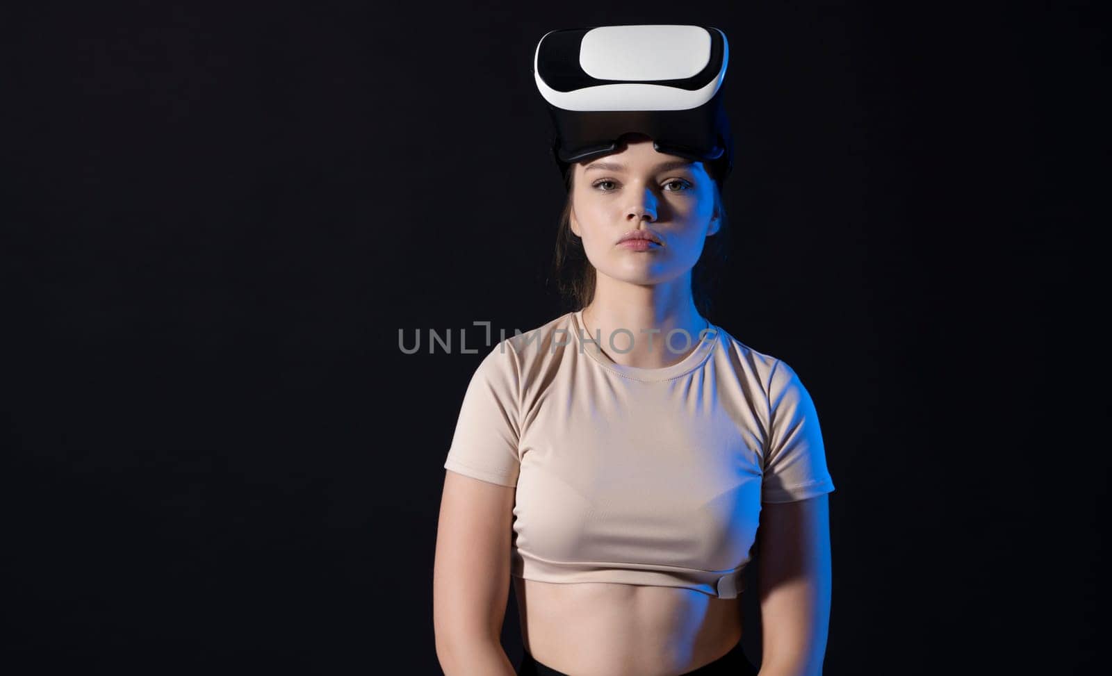 Metaverse and virtual technology concept. Young woman in virtual reality headset. by vovsht