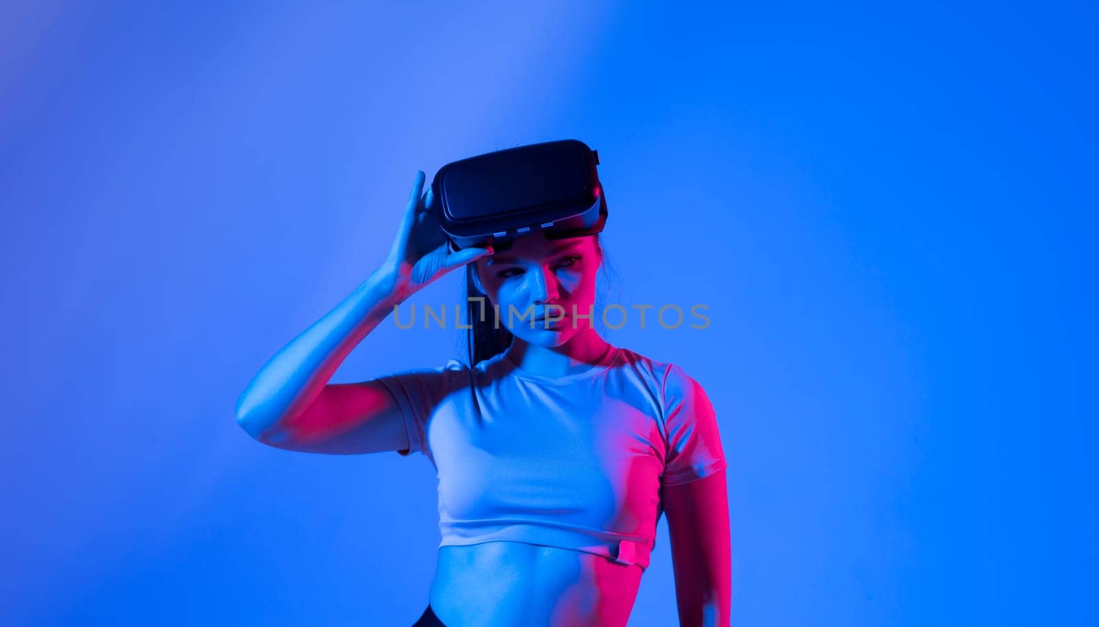 Portrait of brunette woman getting experience in metaverse using VR headset glasses. Exploring a cyberspace via virtual reality