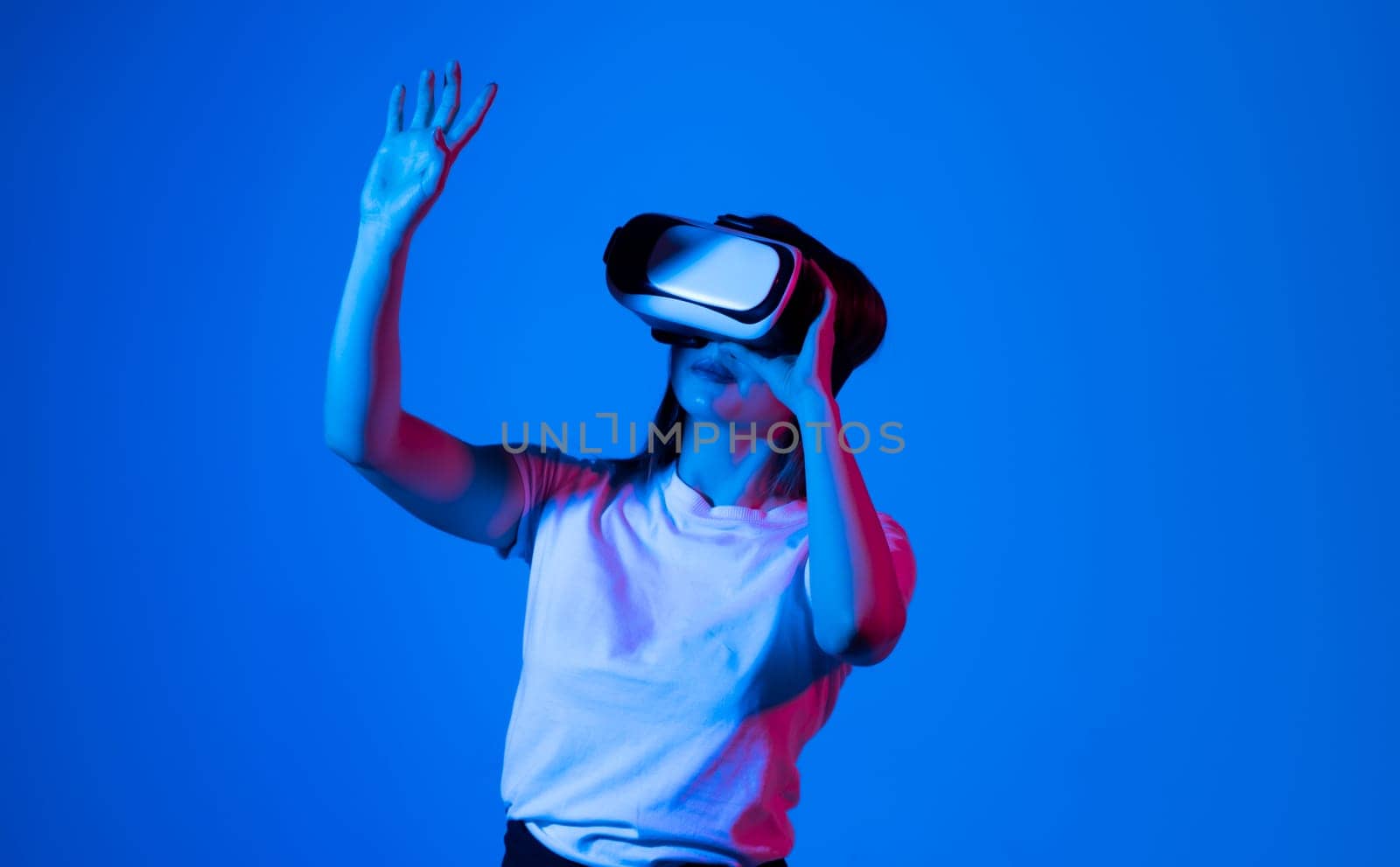 Excited brunette woman in vr headset in a studio. by vovsht