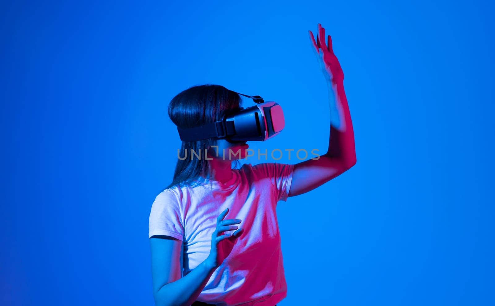 Woman getting experience in metaverse using VR headset glasses. Exploring a cyberspace via virtual reality. by vovsht