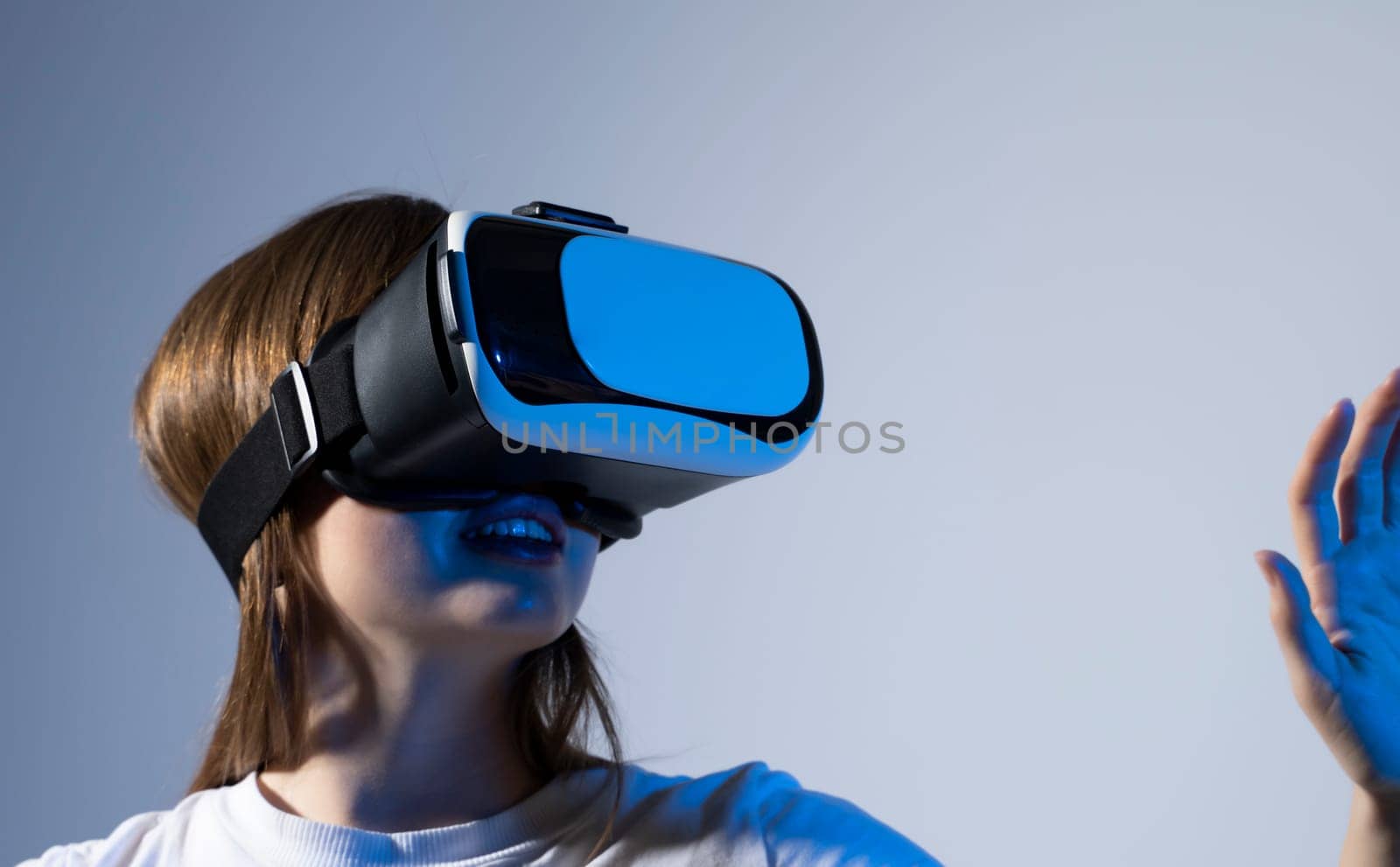 VR technologies. Confident young woman in virtual reality headset pointing in the air