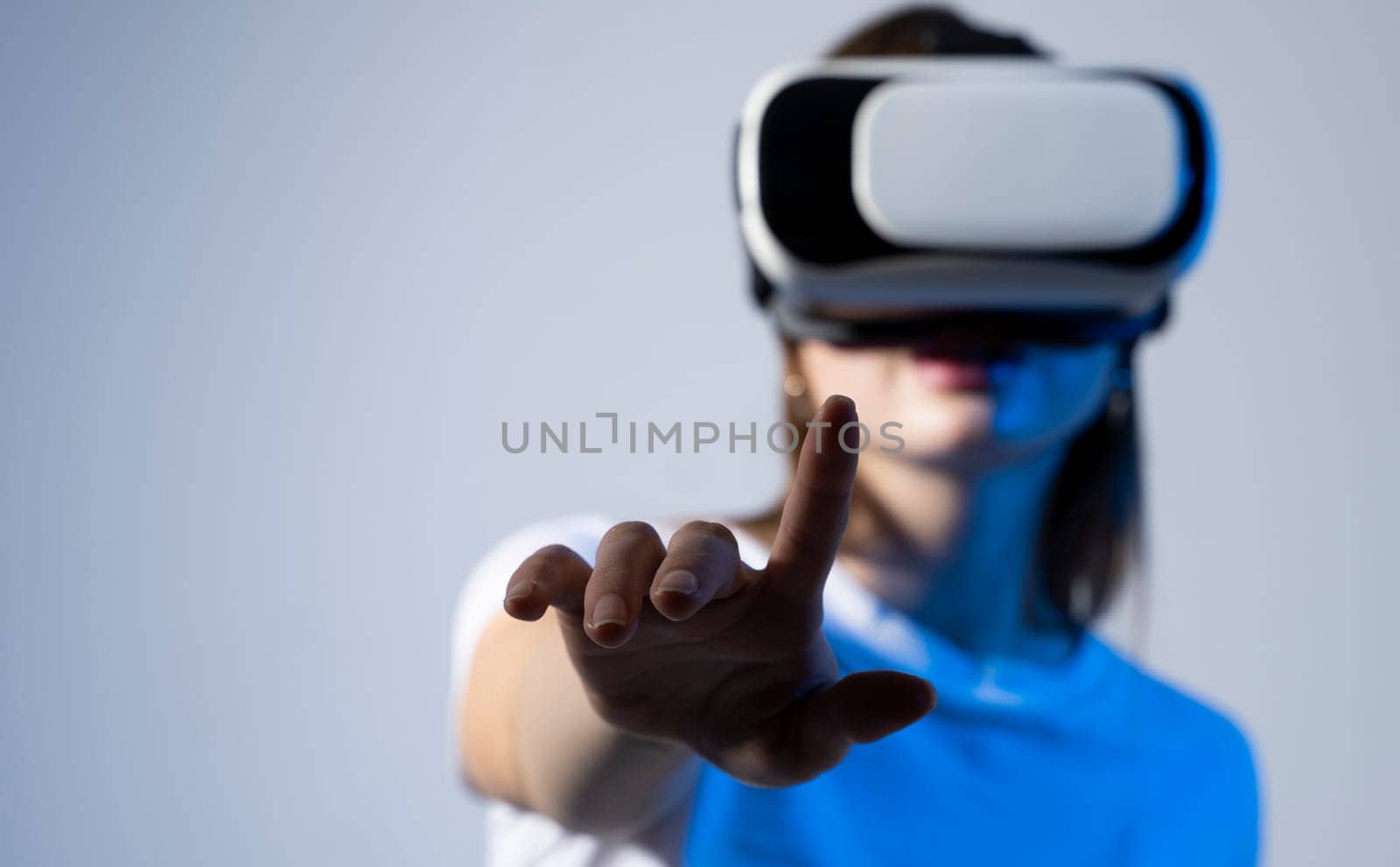 Metaverse, woman in white shirt wearing vr glassess. VR set equipment for virtual reality