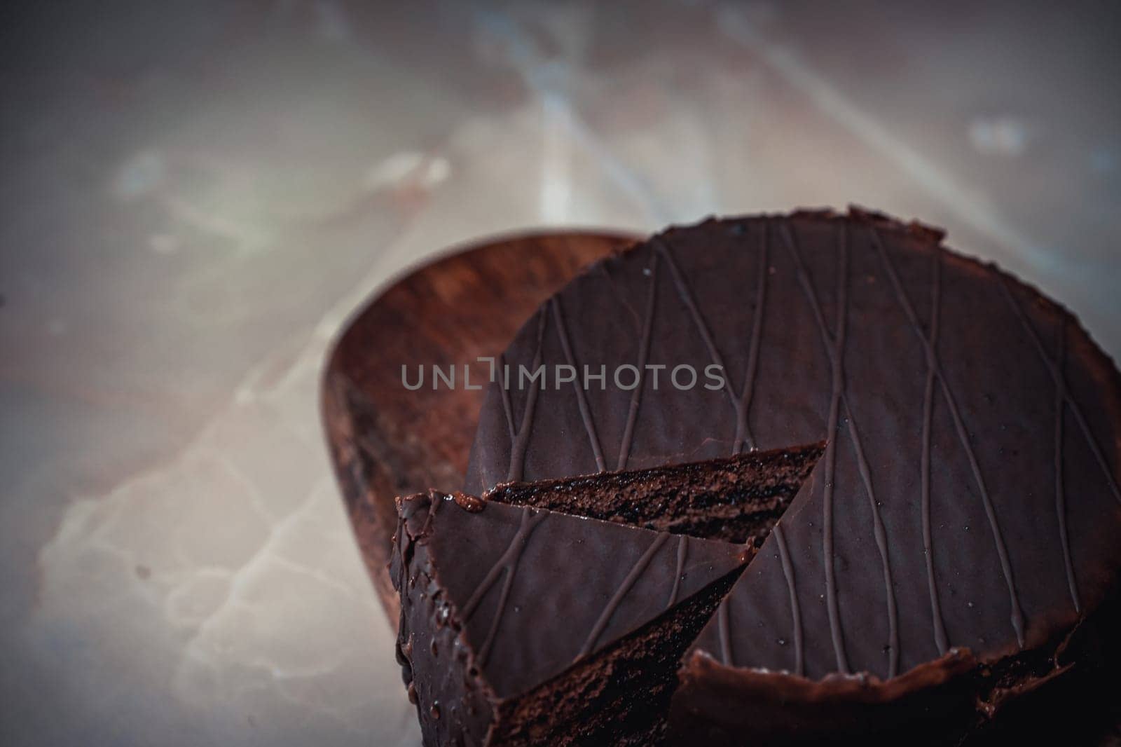 Round chocolate cake with triangular slice cut off. High quality photo
