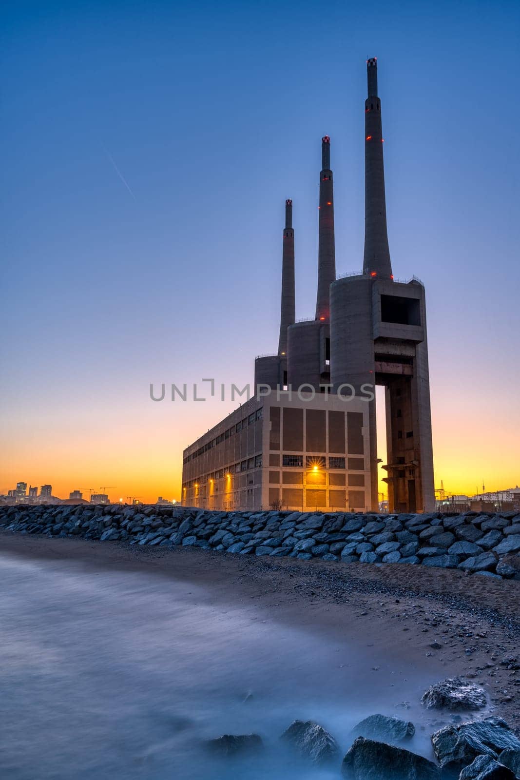 The decommissioned thermal power station at Sant Adria near Barcelona after sunset
