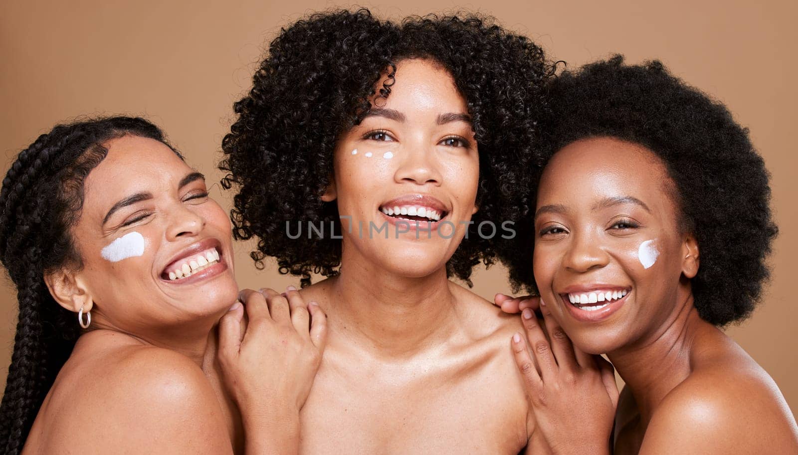 Beauty skincare, friends and black women with face cream in studio for moisturizing on brown background. Portrait, smile and group of models with facial lotion or cosmetics product for healthy skin